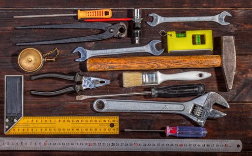 A top view of hand-building tools kit on a wooden table