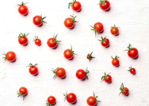 A closeup shot of a bunch of cherry tomatoes isolated on a white background