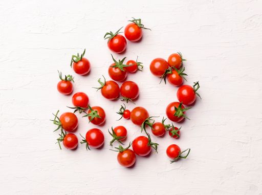 A closeup shot of a bunch of cherry tomatoes isolated on a white background