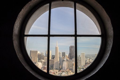 View of the buildings of San Francisco's Downtown seen from one of the windows of the Coit Tower