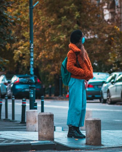 A mesmerizing shot of some people walking down a street in the evening in autumn