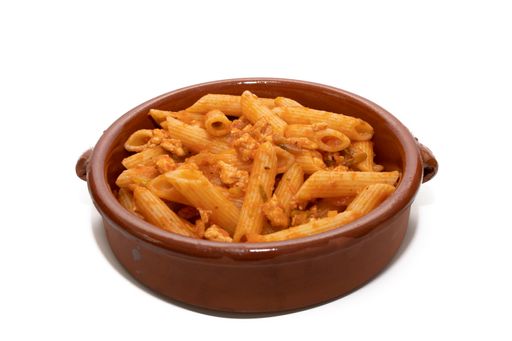 A close-up shot of delicious macaroni with tomato sauce in a clay bowl isolated on a white background