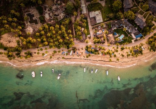 A beautiful overhead shot of houses and small boats parked near the seashore
