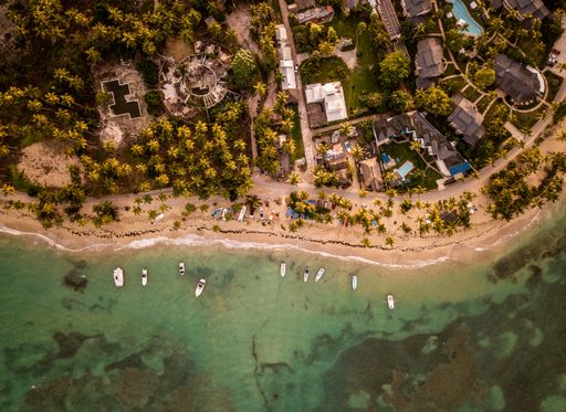 A beautiful overhead shot of houses and small boats parked near the seashore