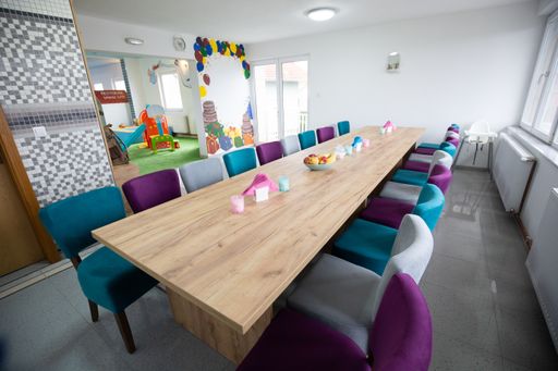 A wide shot of an empty dining area at a daycare center
