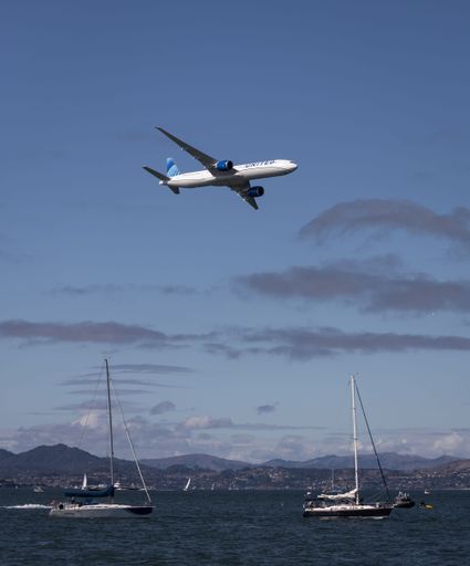 United Airlines 777 flying over San Francisco during Fleet Week