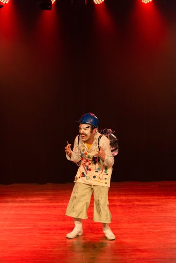 A vertical shot of an actor in costume playing on a stage in a theater in the city of Salvador, Brazil