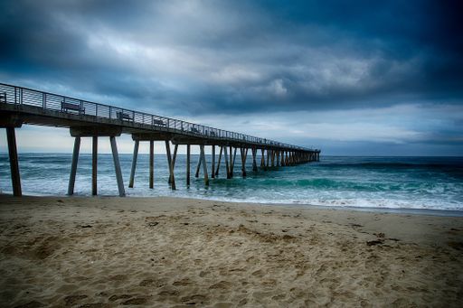 A beautiful shot of the Hermosa Beach Pier with a background of blue sky.