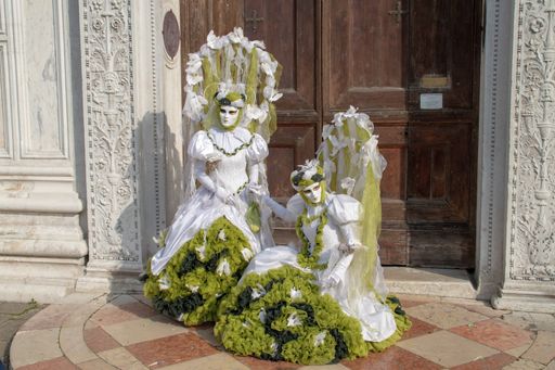 Two people wearing tree costumes during the Carnival in Venice