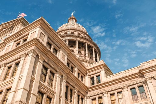 A low angle shot of Texas Capitol building under a blue beautiful sky. Austin city, Texas
