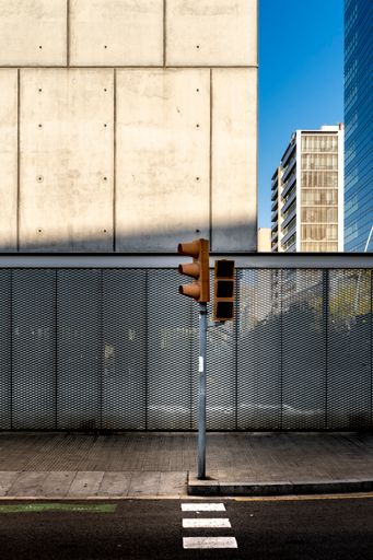 A vertical shot of the traffic lights on a sunny day in the streets of Barcelona