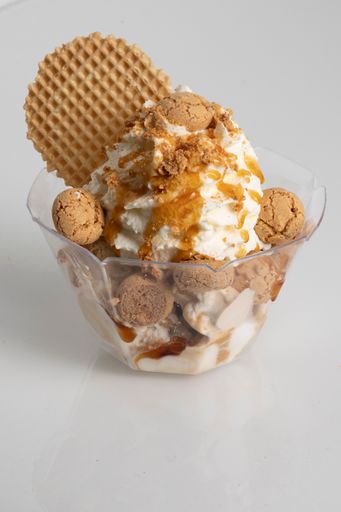 A vertical shot of ice cream in a small plastic bowl isolated on a white background