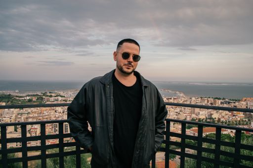 A Caucasian man from Spain with trendy hair, a leather jacket and sunglasses