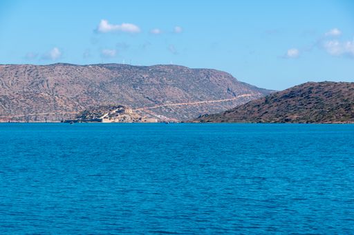 The beautiful shot of mountain town landscape with  turquoise lake water scene taken from a boat