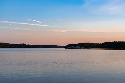 A beautiful shot of a lake under a cloudy skies in Finland