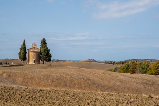 The Chapel of the Madonna di Vitaleta surrounded by fir trees, Italy
