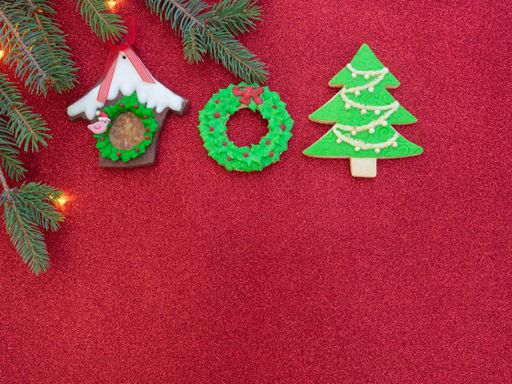 Homemade gingerbread cookies in the shape of a Christmas tree, wreath, and birdhouse
