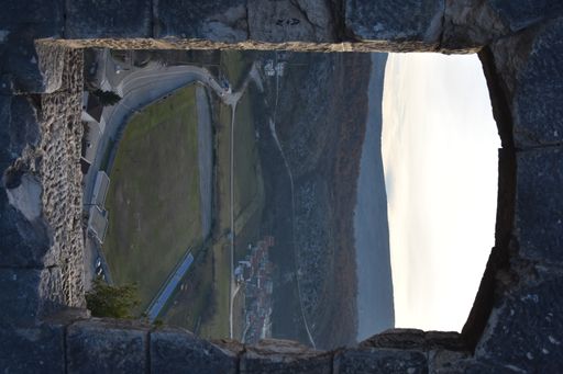 A landscape through rough stone window