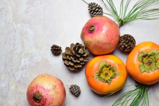 Autumn composition with ripe fruits, leaves, pine cones and needles in the grunge background with a copy space on the  left