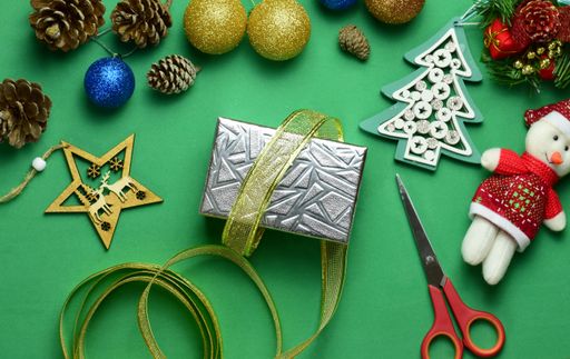 Festive background with colorful baubles and toys; preparing gift boxes for Christmas
