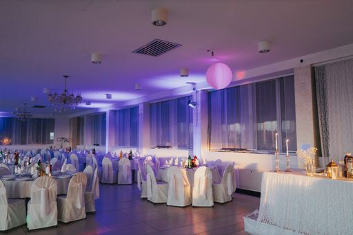 The restaurant with tables and chairs decorated in white - preparation for the wedding