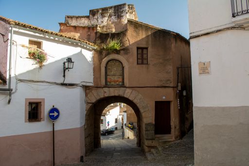 Caceres, Spain, April 2017: Calle Cuesta del Marques and entry gate to the old town in Caceres, Extremadura in Spain