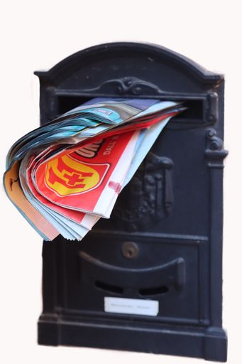 A vertical shot of a letterbox with advertising