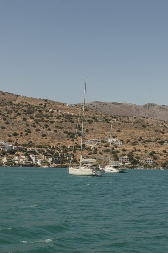 A beautiful scene with sailboats floating along the Crete island coastline, Greece