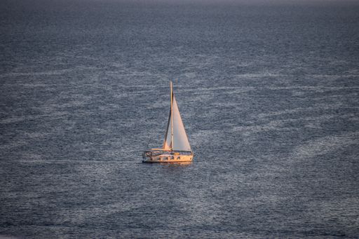 A beautiful view of a small boat in a waving sea