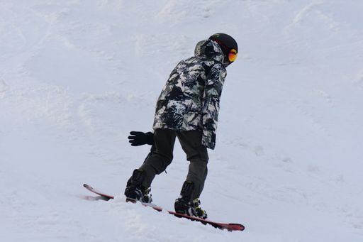 A young man on a snowboard on a slope in the Carpathian Mountains in Ukraine