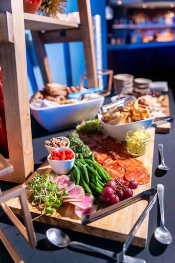 a vertical shot of delicious appetizers beautifully placed on a wooden surface for an event