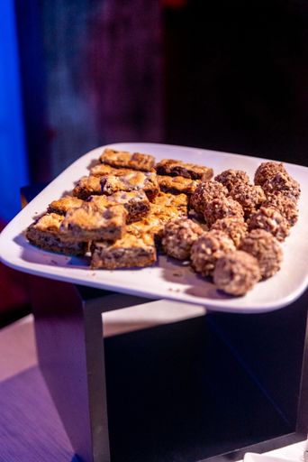 a vertical shot of delicious fresh-baked desserts placed in a white plate with a dark background