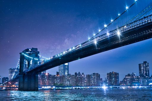 A low angle shot of the famous illuminated Brooklyn bridge park in New York City, USA