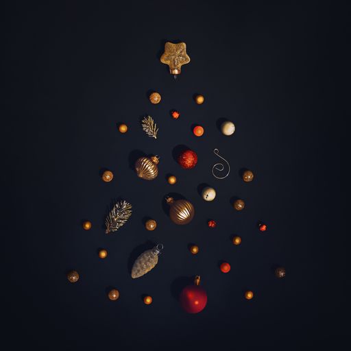 A Christmas tree made of colorful ornaments and balls on black background