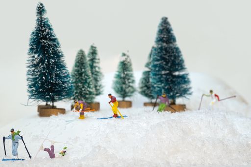 A group of miniature figures of skiers on a white background