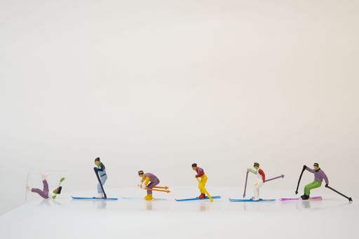 A group of miniature figures of skiers on a white background