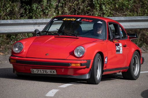A man driving Porsche 911 SC VIII Rallye on a highway in Catalonia, Spain