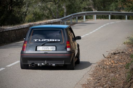 A man driving Renault 5 GT Turbo Rallye on a highway in Catalonia, Spain
