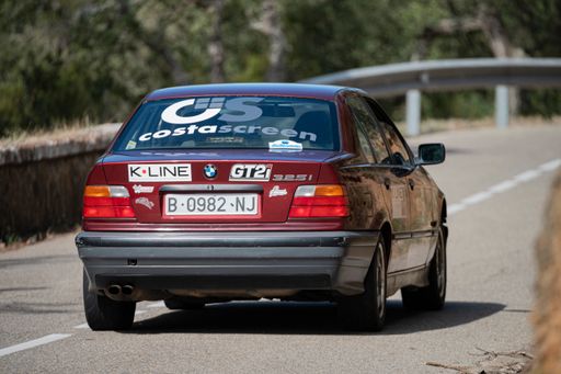 A man driving BMW 325i E36 VIII Rallye on a highway in Catalonia, Spain