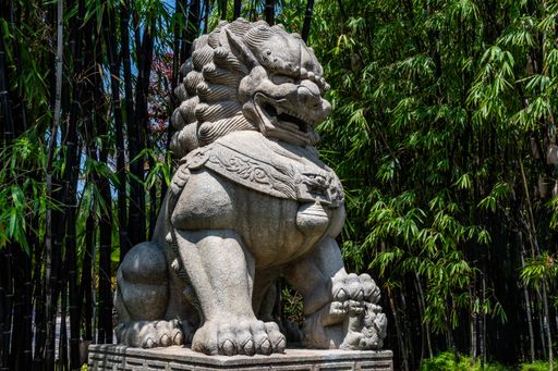 An amazing shot of a stone sculpture of a big lion located in the Gardens by the Bay in Singapore