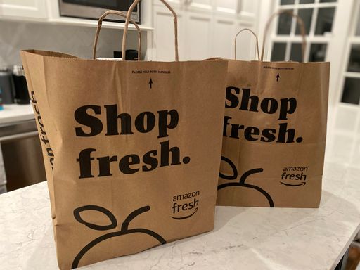 The paper grocery bags on a kitchen counter from the Amazon Fresh store