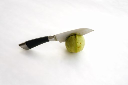 An amazing shot of a knife embedded in a fruit
