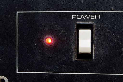 A closeup of a Power switch on or off from an old amplifier