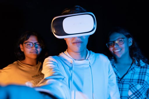 A young Hispanic male experiencing virtual reality for the first time on a black background