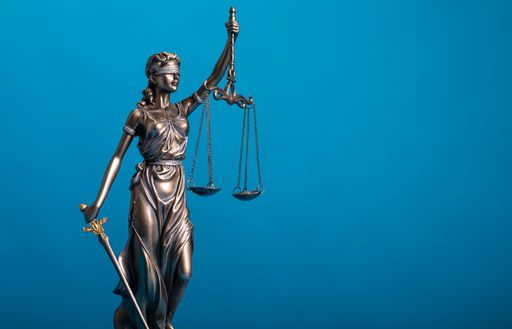 A closeup shot of a statue of justice holding scales