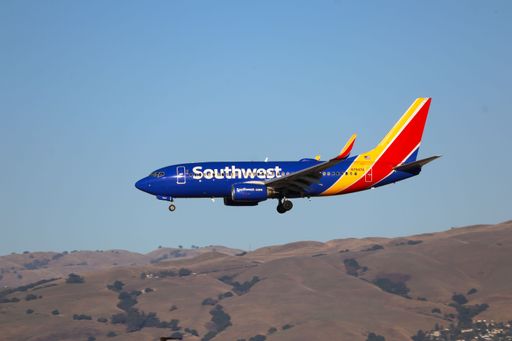 Southwest Airlines Boeing 737-700 lands at San Jose airport with Diablo mountains in the backdrop.