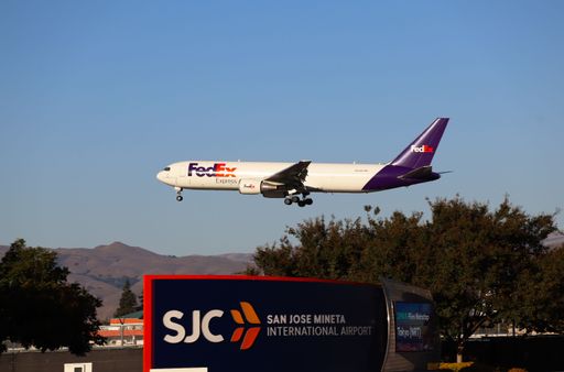 FedEx Boeing 767-300 approaches San Jose Airport over SJC sign, arriving from Oakland.