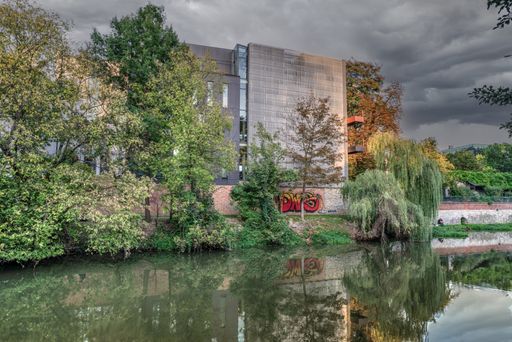 A beautiful view of a building on a pond water lake of the City Library in Opole, Poland