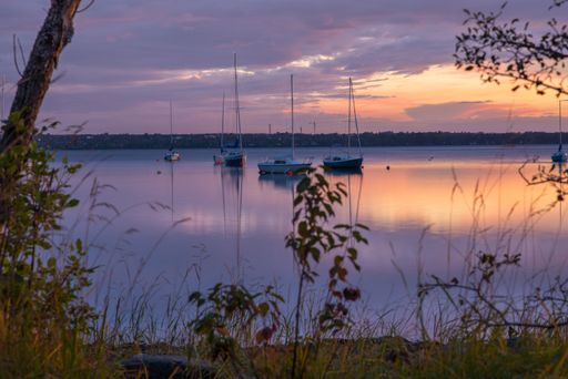 The boats in the lake during the sunset
