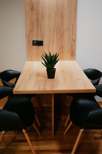 A vertical shot of a modern interior of a room with a wooden table and chairs